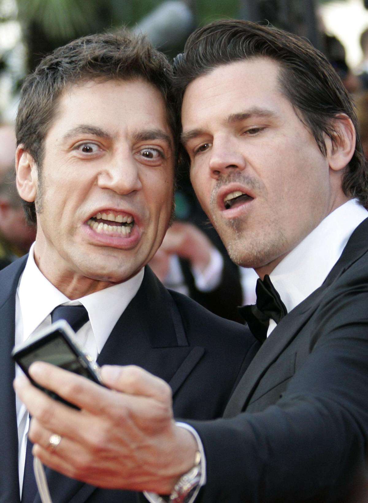 Cast members Bardem and Brolin take their own pictures at the 60th Cannes Film Festival