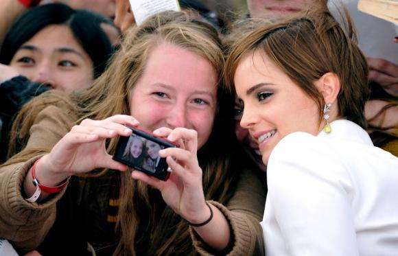 PActress Emma Watson poses with fans at the world premiere of "Harry Potter and the Deathly Hallows: Part 2" in London