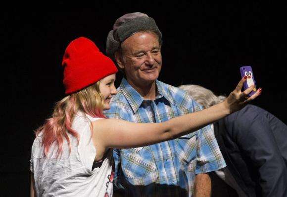 A fan takes a selfie with Bill Murray following a screening of "Ghostbusters" at the Toronto International Film Festival in Toronto