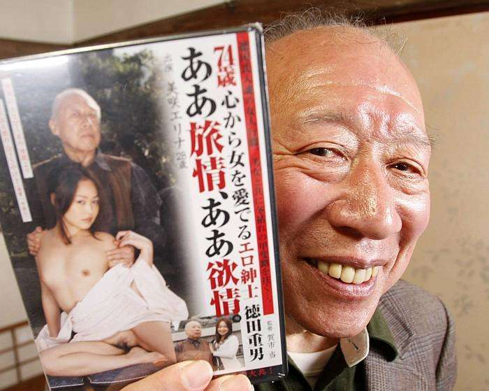 Pornographic movie actor Shigeo Tokuda poses with his DVD title before the shooting of his latest film in Ichikawa