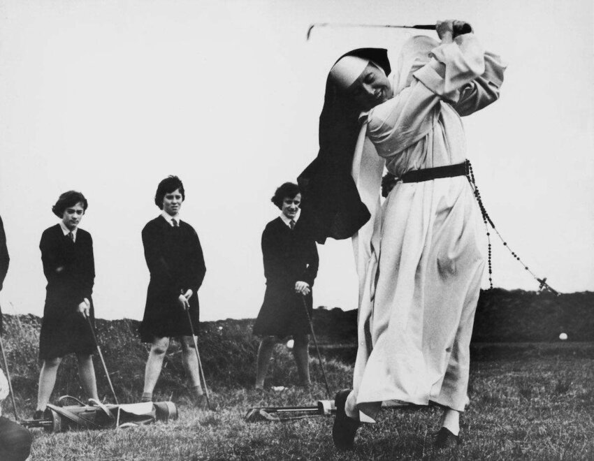 Nun, and golf coach, Sister Mary Martina takes an iron shot on the golf course at Rosebud Country Club, Portsea, Victoria, Australia, 6th September 1965. Looking on are girls from St Mary's School For The Deaf, who, along with Sister Mary Martina, are being coached by the club's proffessionals. (Photo by Central Press/Hulton Archive/Getty Images)