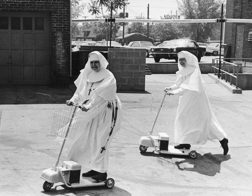 Sister Mary Thomas (right), an administrator at St Elizabeth's Hospital, convinces another nun of the convenience of an electric scooter, circa 1955. (Photo by Three Lions/Hulton Archive/Getty Images)