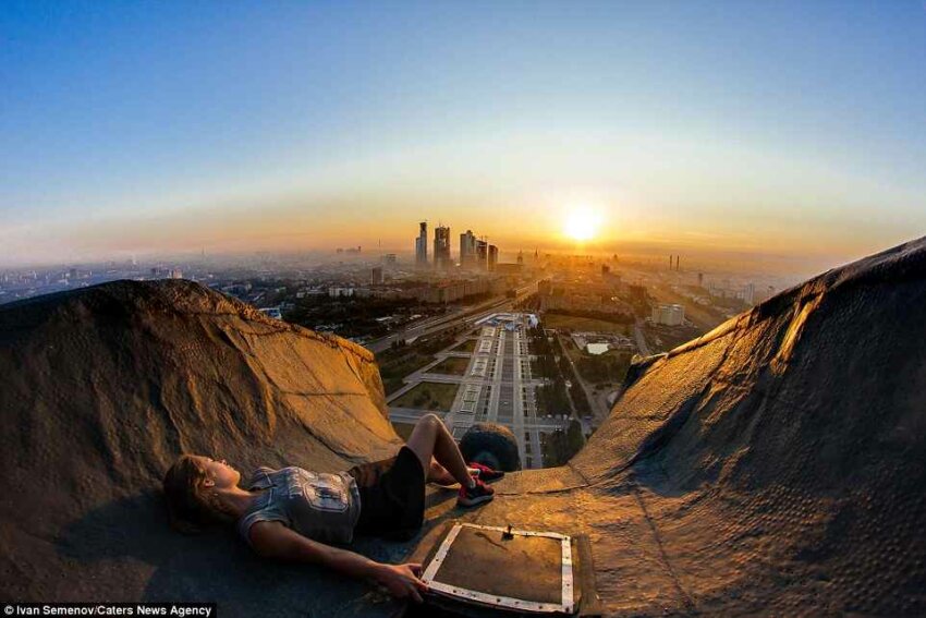Russian_rooftopper_relaxes_as_she_watches_the_Moscow_sunset