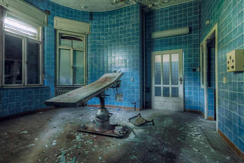 horror operation table in forgotten blue room in a hospital