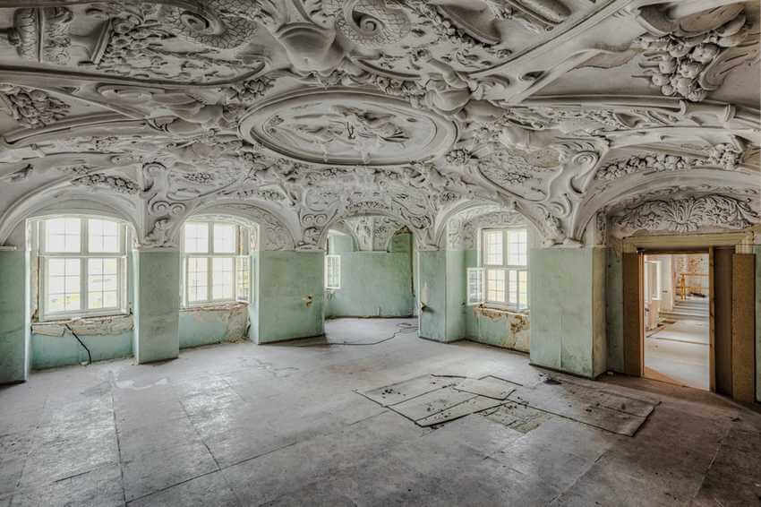 abandoned room with baroque ceiling