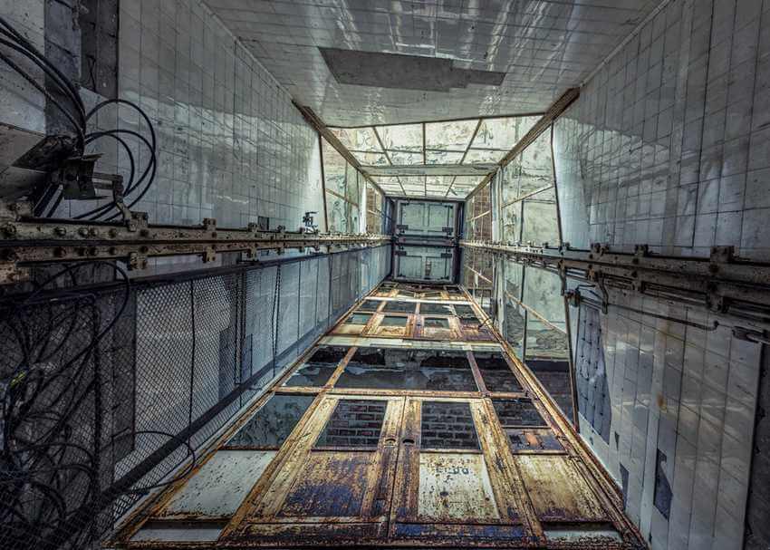 abandoned elevator in hospital with rusty doors