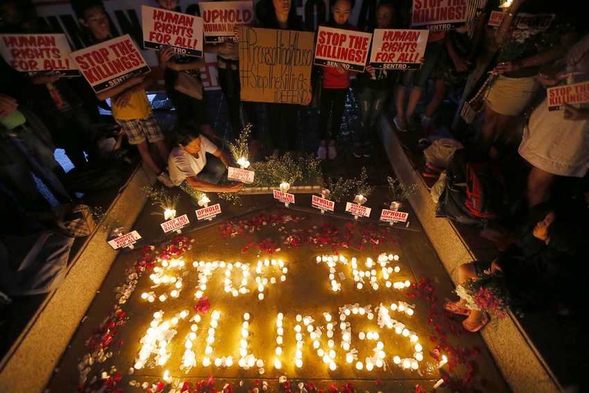 Human rights activists light candles for the victims of extra-judicial killings around the country in the wake of "War on Drugs" campaign by Philippine President Rodrigo Duterte Monday, Aug. 15, 2016 in suburban Quezon city, northeast of Manila, Philippines. The "war on drugs" campaign, which saw hundreds of mostly poor victims, has been condemned by human rights groups including the United Nations Chief Ban Ki-moon. (AP Photo/Bullit Marquez)