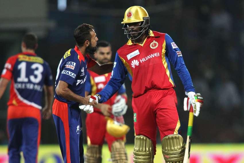 Imran Tahir of the Delhi Daredevils and Chris Gayle of the Royal Challengers Bangalore shake hands as Royal Challengers Bangalore beat Delhi Daredevils by 10 wickets during match 26 of the Pepsi IPL 2015 (Indian Premier League) between The Delhi Daredevils and The Royal Challengers Bangalore held at the Ferozeshah Kotla stadium in Delhi, India on the 26th April 2015. Photo by: Shaun Roy / SPORTZPICS / IPL